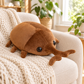 Dark dung beetle plushie on a cozy armchair