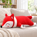 Red fox plushie pillow on a living room sofa