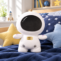 Astronaut space buddy plushie on a cozy bed