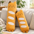 Long baguette cat plushie on a living room sofa