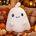 Cute ghost plushie on an autumn sofa