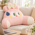 Pink rabbit resting cushion pillow on a sofa